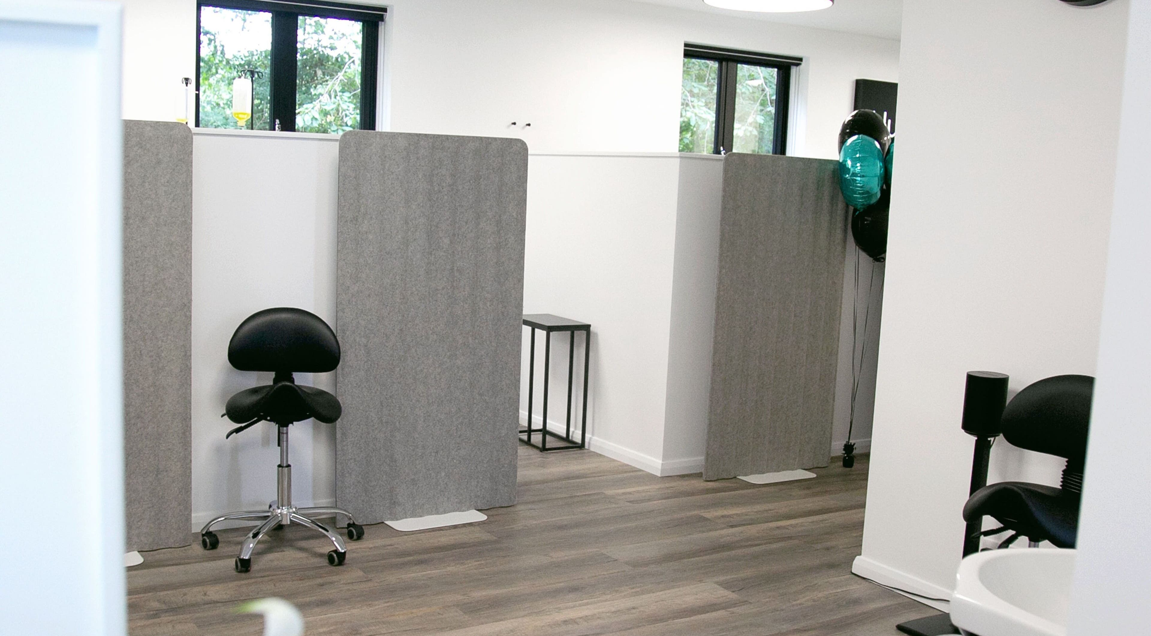 Modern treatment area at NutriZen Wellness Centre, Wolverton, England, GB, featuring minimalist design and seating.