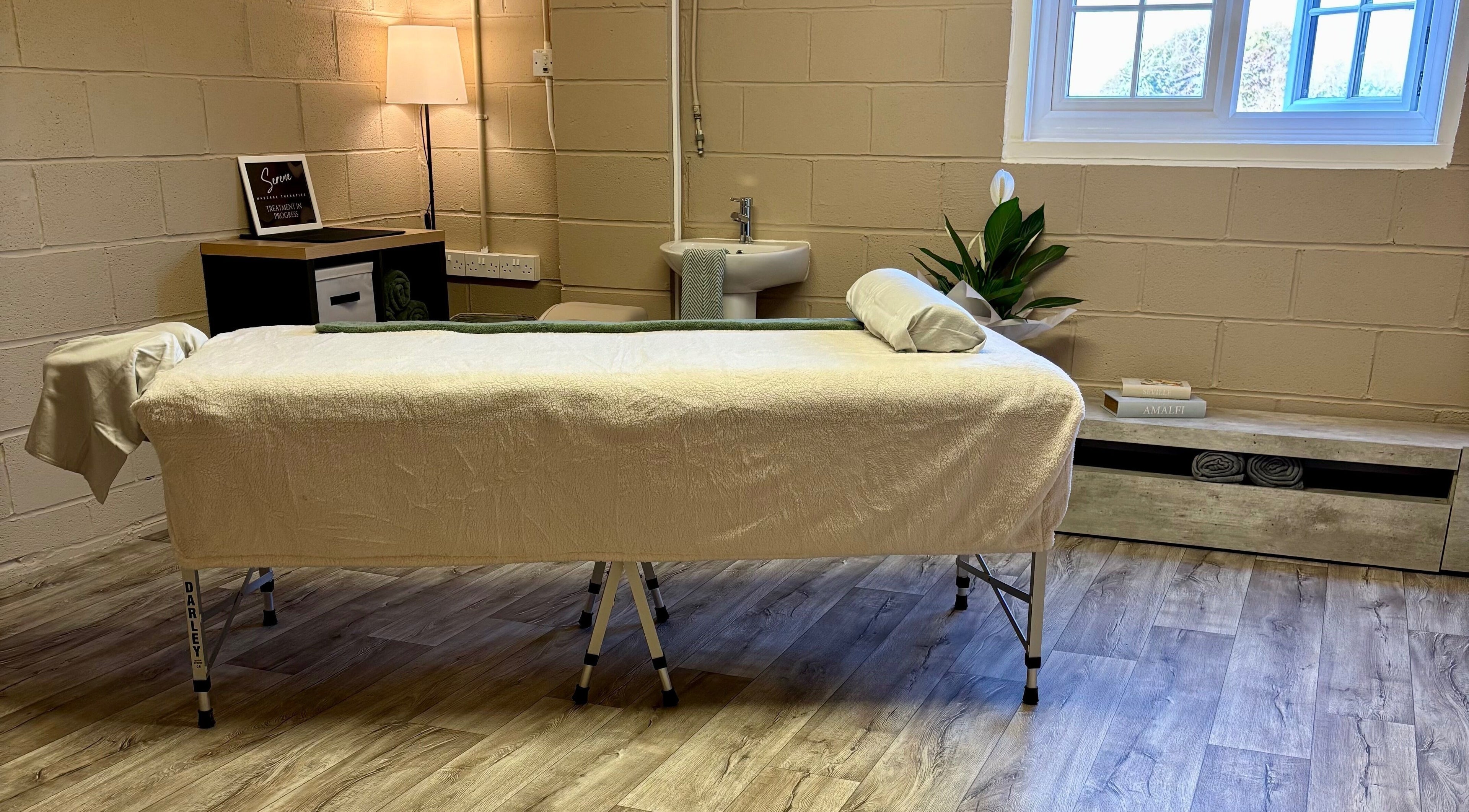 Relaxing therapy room at Serene Massage Therapies, Faversham, England, GB with soft lighting and a cozy treatment bed.