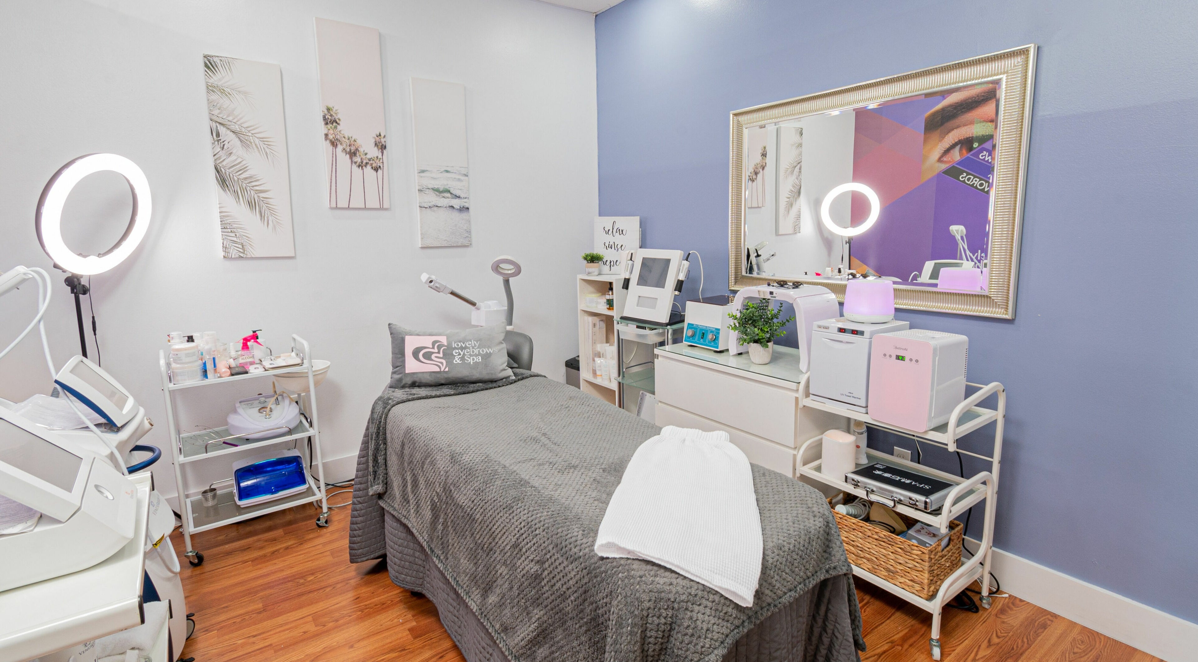 Relaxing treatment room at Doral Lovely Eyebrow Spa, Doral, Florida, US featuring modern skincare equipment.