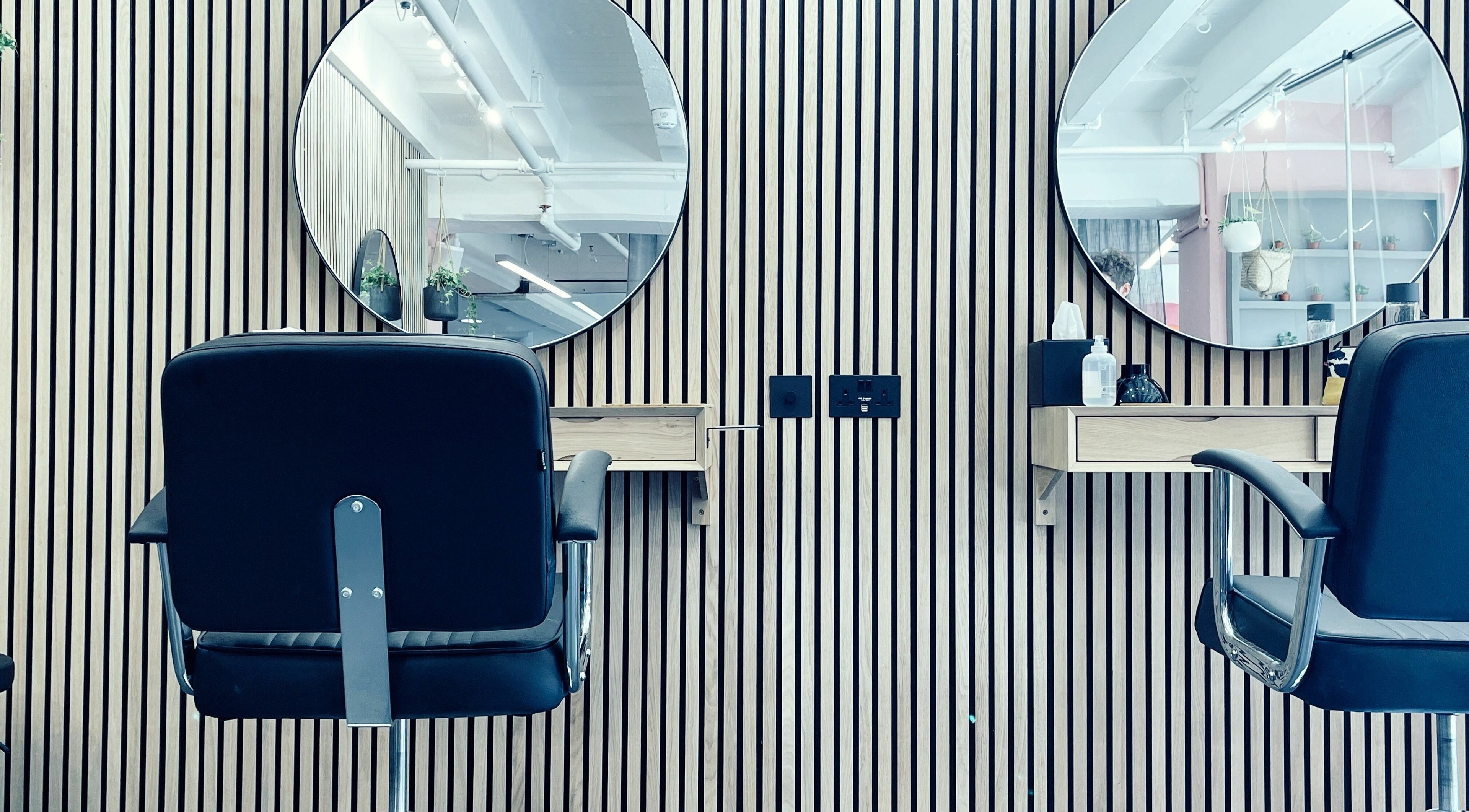 Modern salon chairs and mirrors at Bonney & France - Naedlae in London, England, GB, offering a stylish experience.