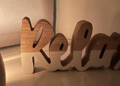 Wooden 'Relax' sign at AJ Massage, London, England, GB, creating a calm ambiance.