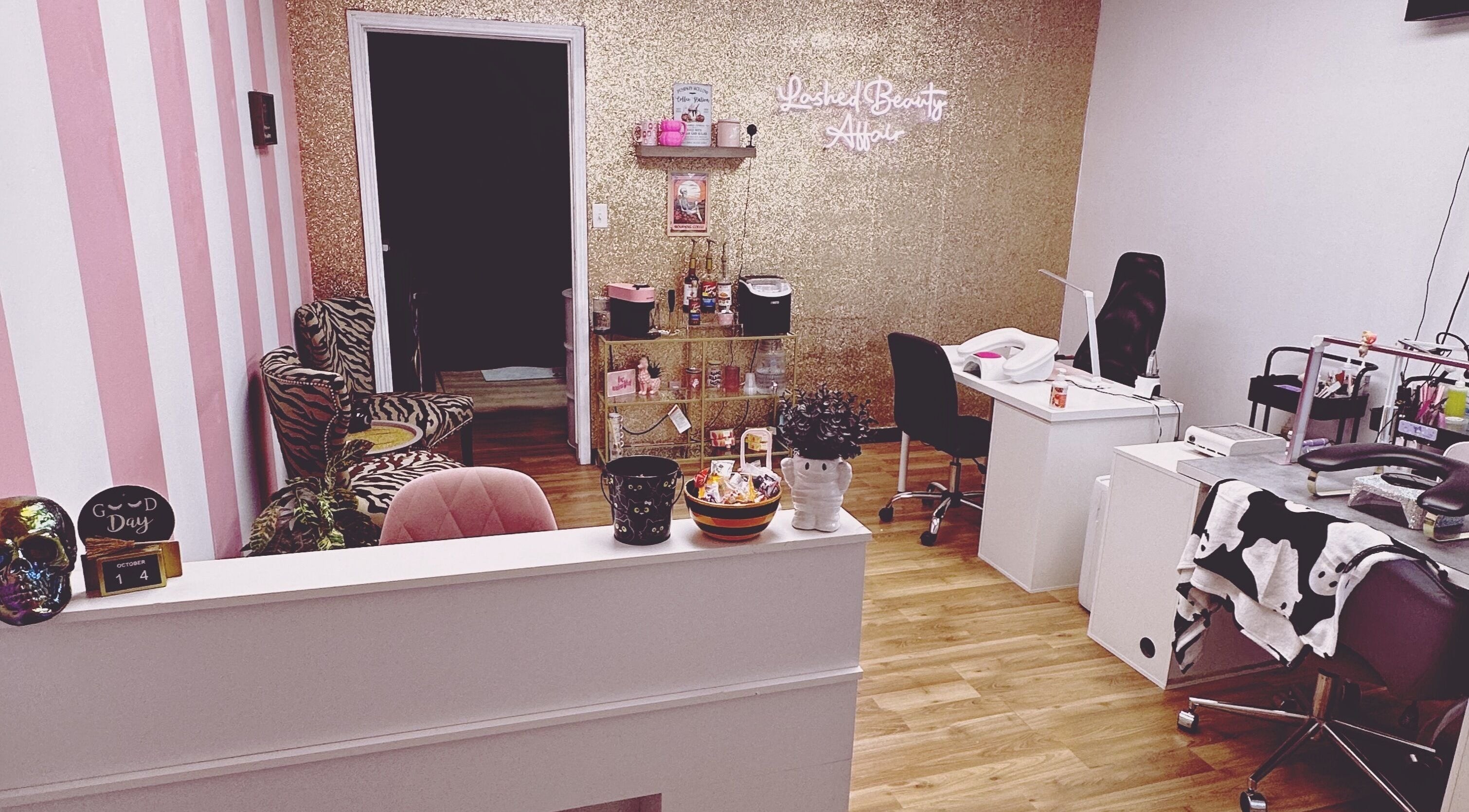 Interior of Lashed Beauty Affair in Hamilton, Ontario, CA with chic decor and cozy chairs.