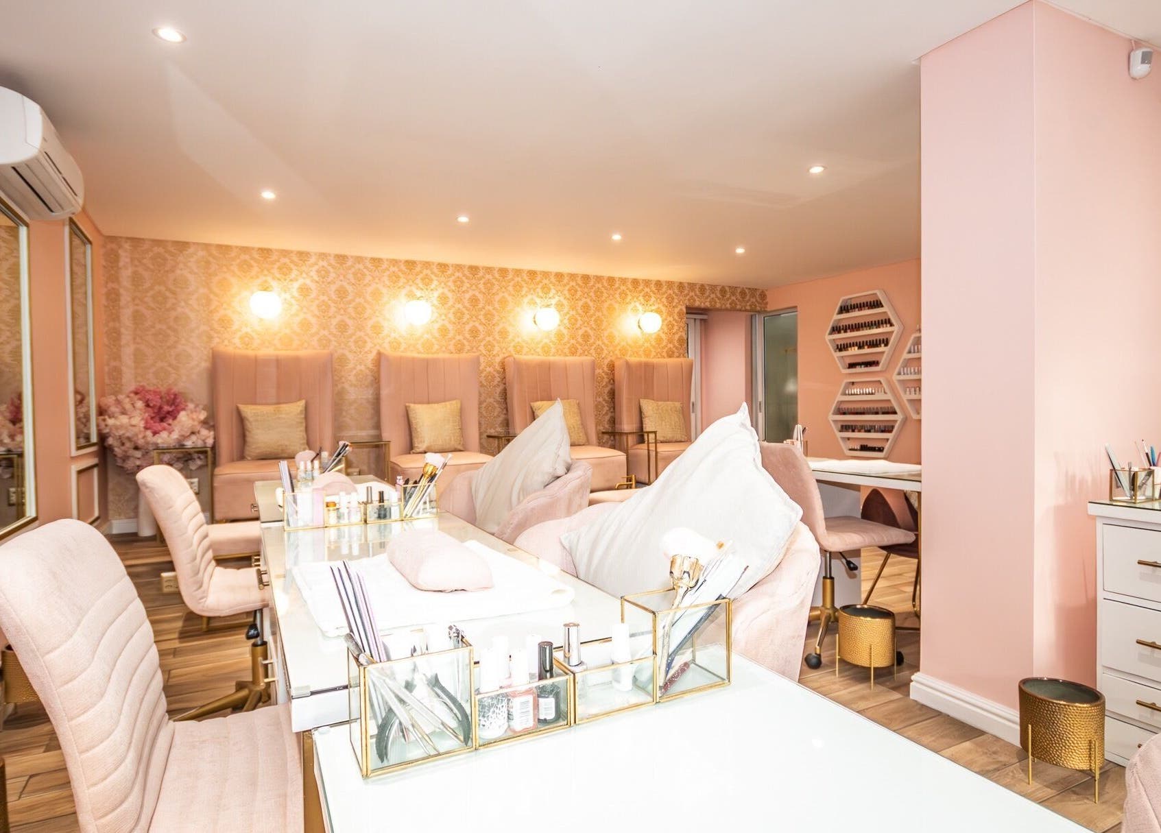 Elegant interior of Rose Blvd Beauty Bar SEA POINT, Cape Town, Western Cape, ZA with plush seating and soft lighting.