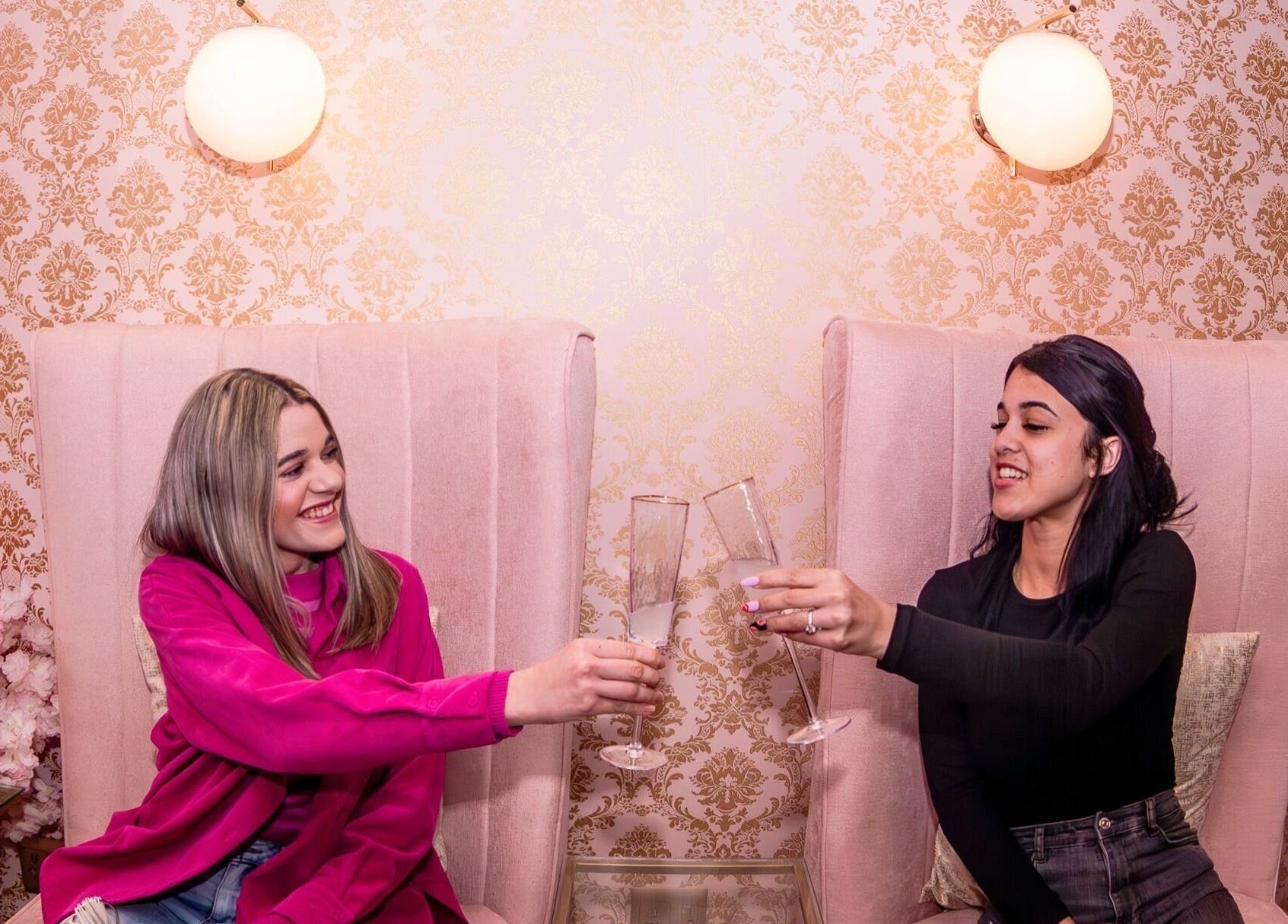 Guests toasting at Rose Blvd Beauty Bar SEA POINT, Cape Town, Western Cape, ZA, in an elegant setting.