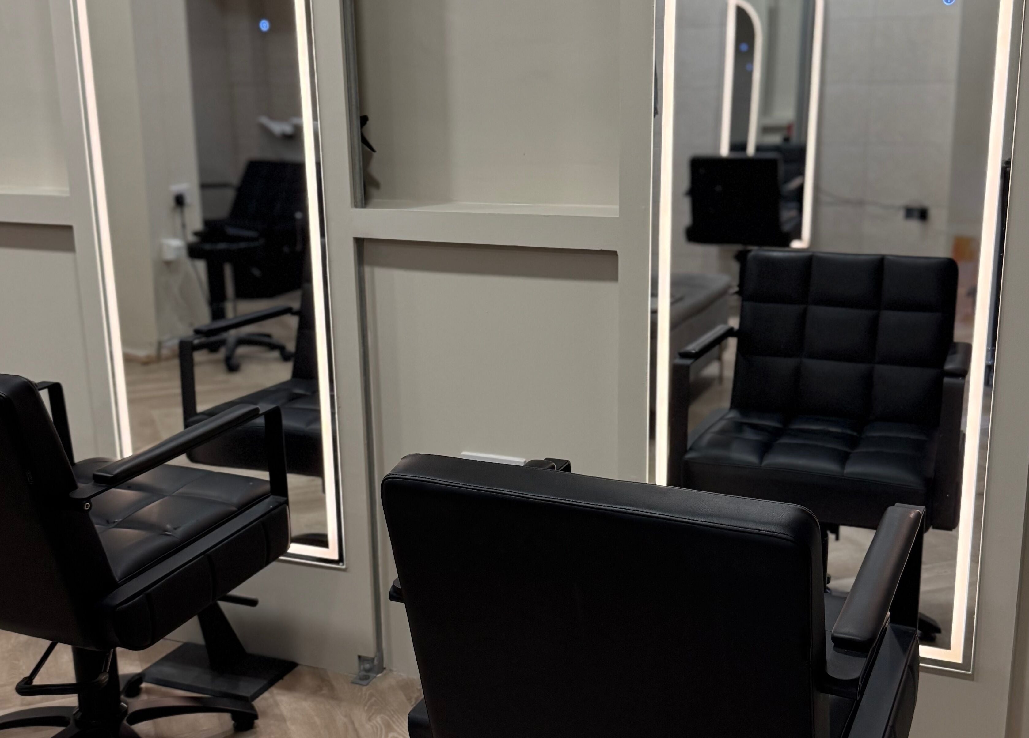 Elegant salon chairs and mirrors at Autumn & Easton, Glasgow, Scotland, GB, offering a premium beauty experience.