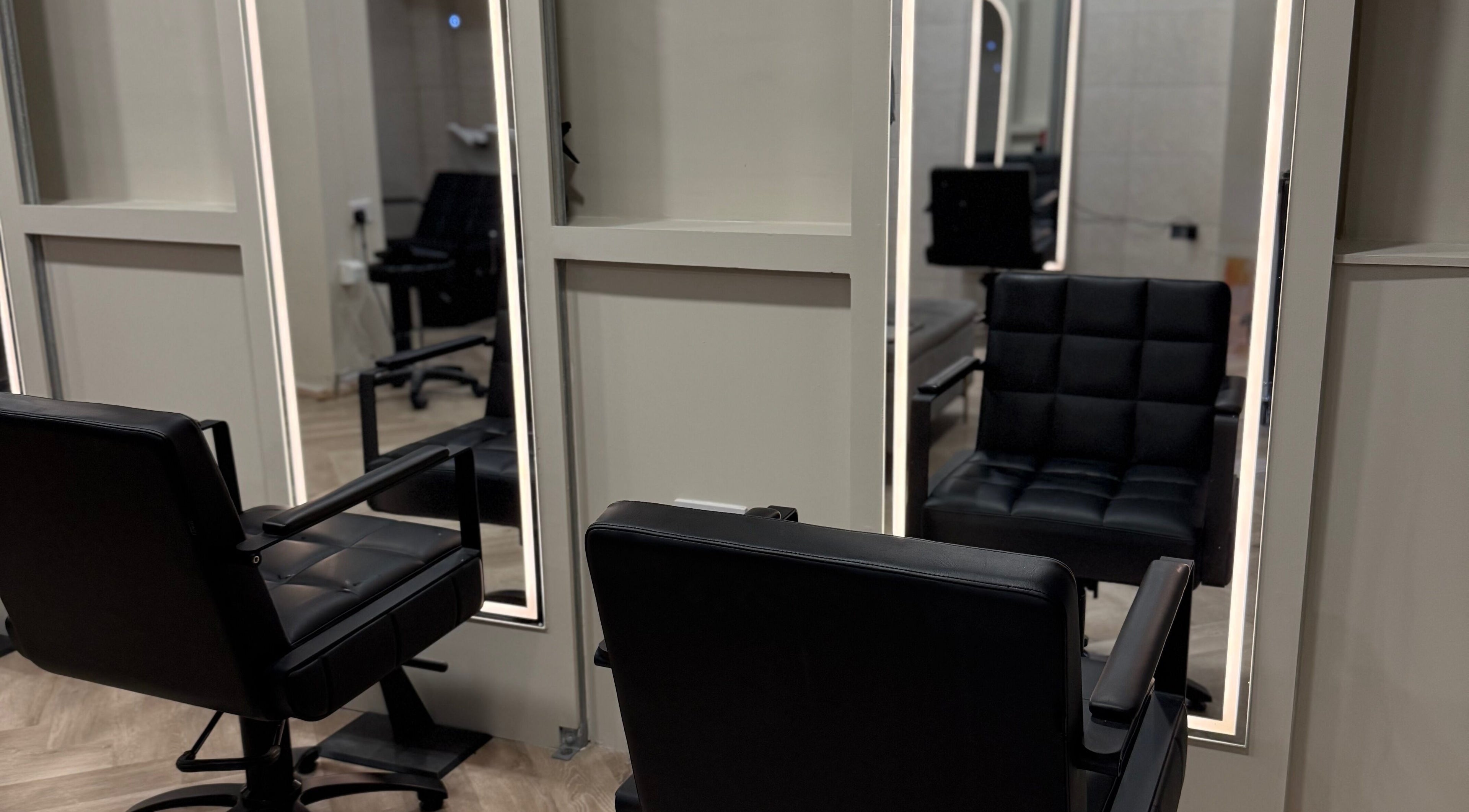 Elegant salon chairs and mirrors at Autumn & Easton, Glasgow, Scotland, GB, offering a premium beauty experience.