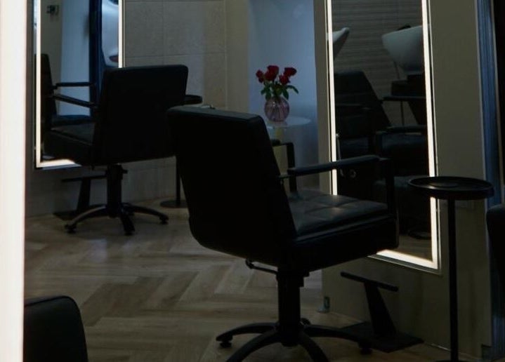 Elegant salon setup at Autumn & Easton, Glasgow, Scotland, GB featuring sleek chairs and stylish mirrors.