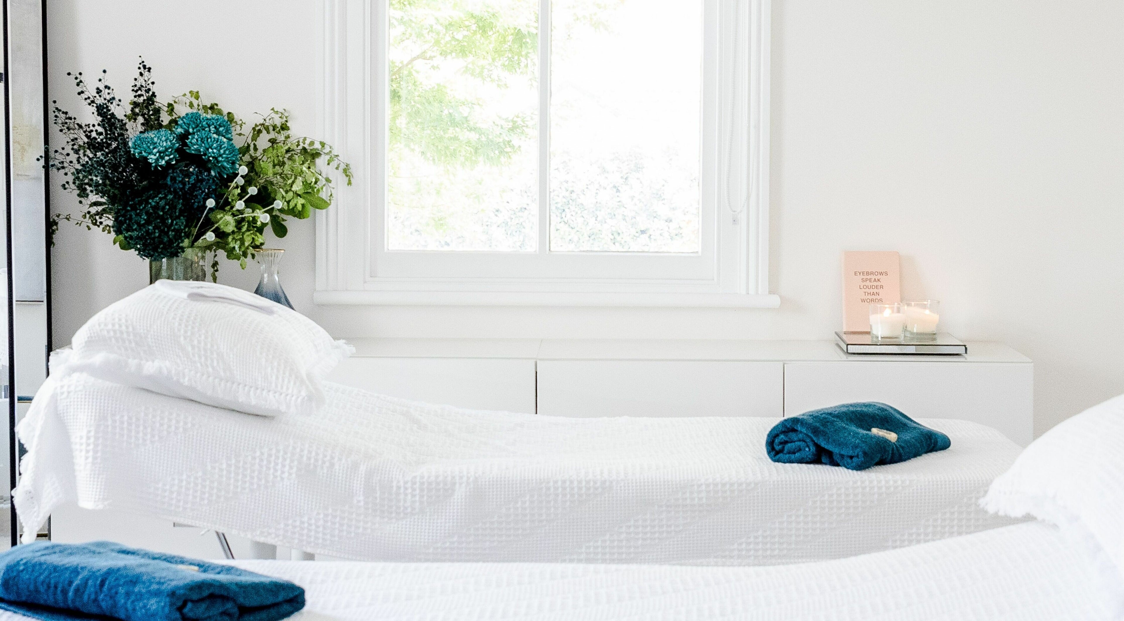 Peaceful treatment room at De'nelle Salon, Gladesville, New South Wales, AU with white decor and calming ambiance.
