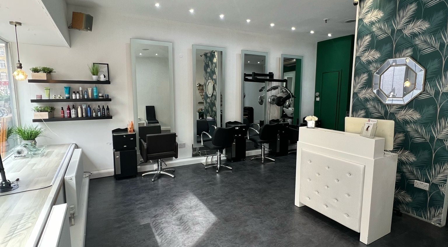 Elegant salon at 8 Harrow Place, London, England, GB with mirrors, styling chairs, and sleek decor.