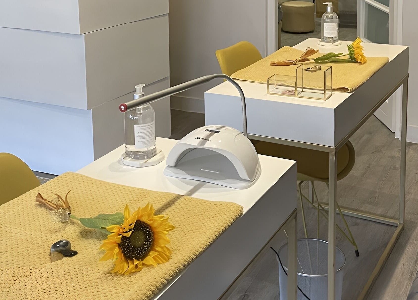 Modern manicure stations at Sana Salon, Cape Town, Western Cape, ZA, featuring sunflowers and elegant decor.