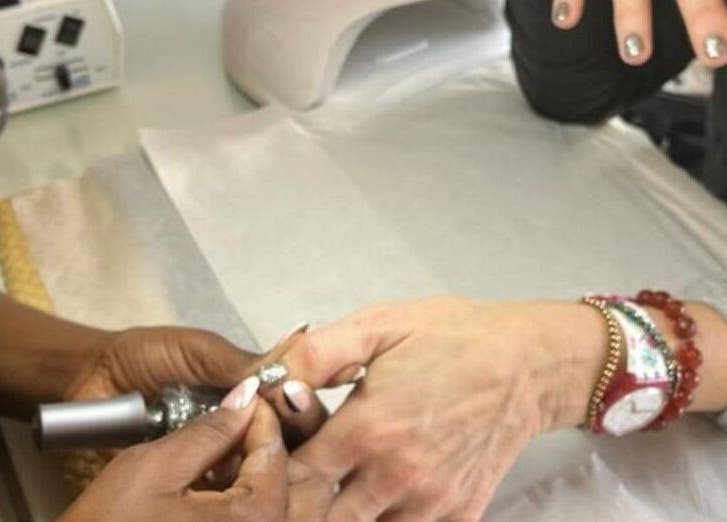 Nail technician giving manicure at Sana Salon, Cape Town, Western Cape, ZA.