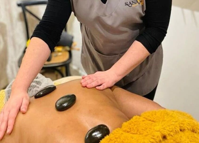 Hot stone massage at Sana Salon, Cape Town, Western Cape, ZA, offering relaxation and rejuvenation.