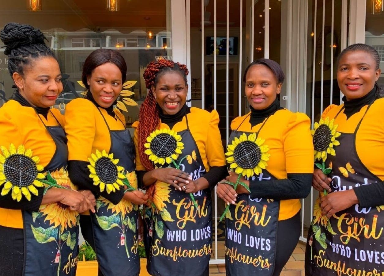 Sana Salon staff in vibrant sunflower attire, Cape Town, Western Cape, ZA, embodying welcoming service.