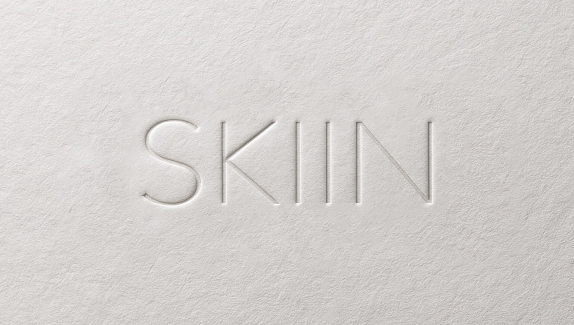 Embossed SKIIN logo on textured paper, Valongo, Porto, PT.