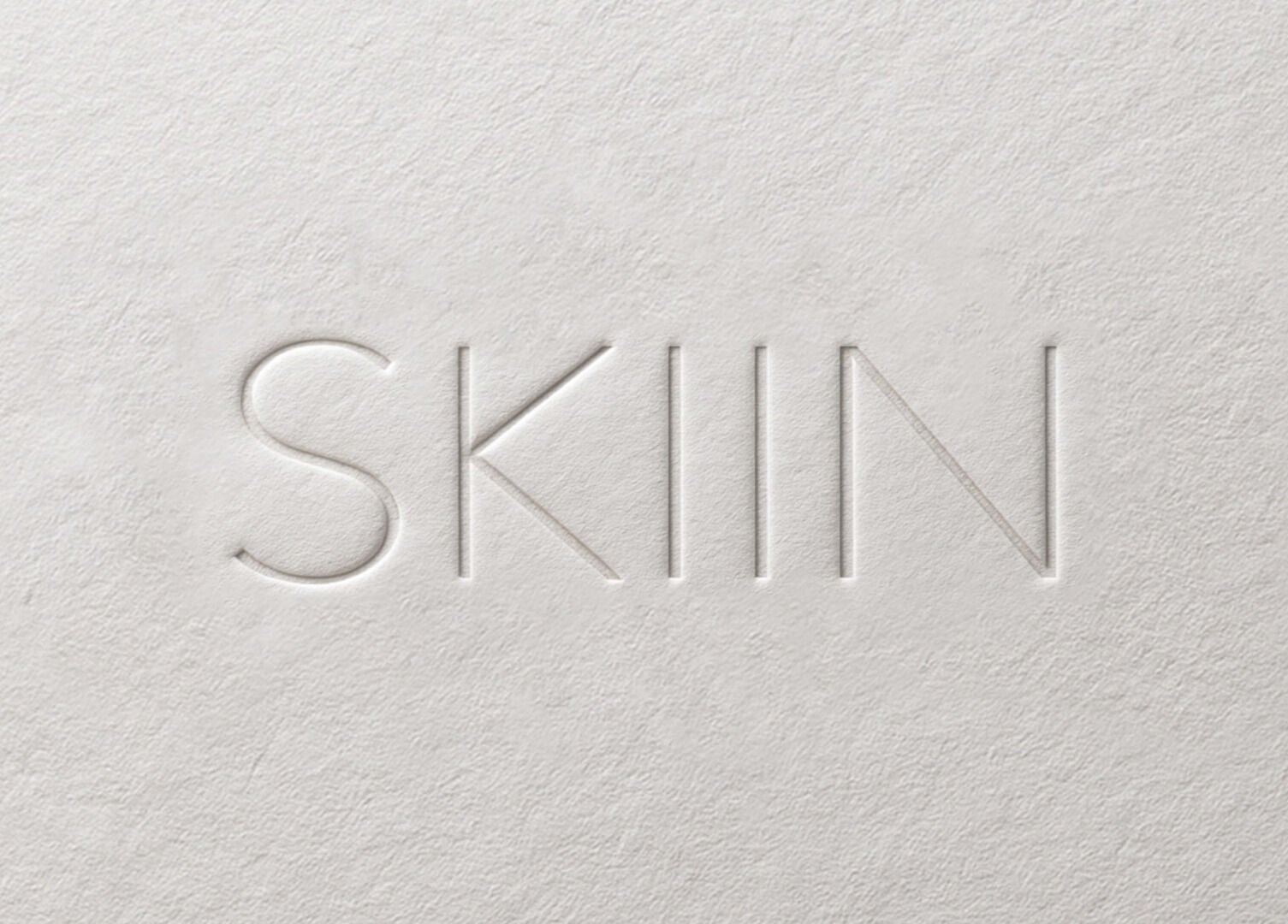 Embossed SKIIN logo on textured paper, Valongo, Porto, PT.