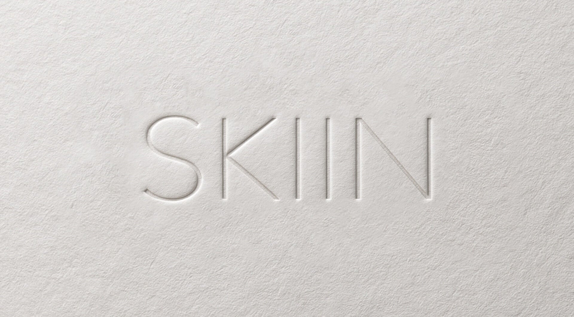 Embossed SKIIN logo on textured background, Valongo, Porto, PT.