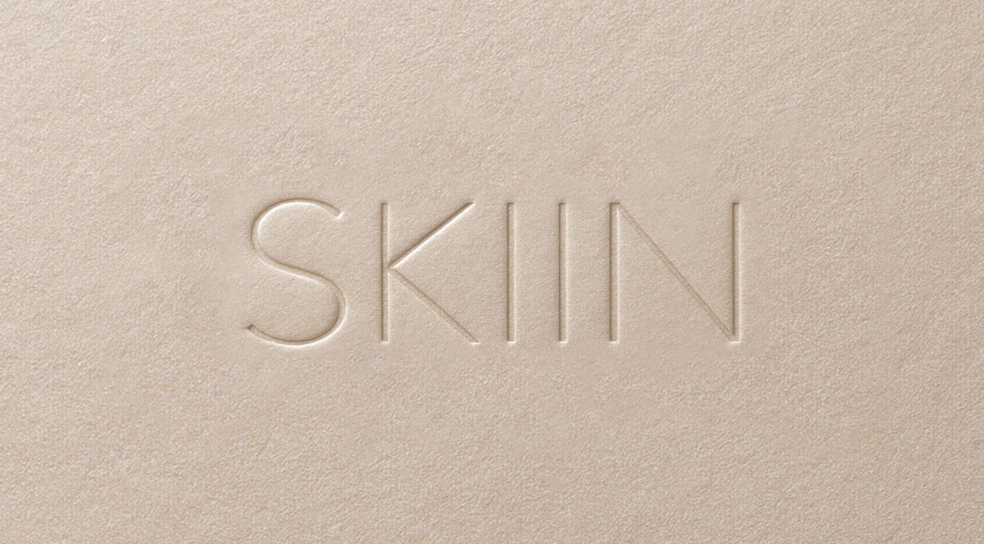 Embossed SKIIN logo on textured background at SKIIN (at VARD, Matosinhos), Matosinhos, Porto, PT.