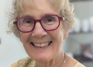 Happy customer with red glasses at Hair Creations by Pagie Xox in Maryville, Illinois, US.