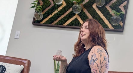 Woman meditating with crystals at Hair Creations by Pagie Xox, Maryville, Illinois, US.