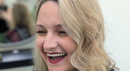 Smiling woman with styled hair at Hair Creations by Pagie Xox, Maryville, Illinois, US.
