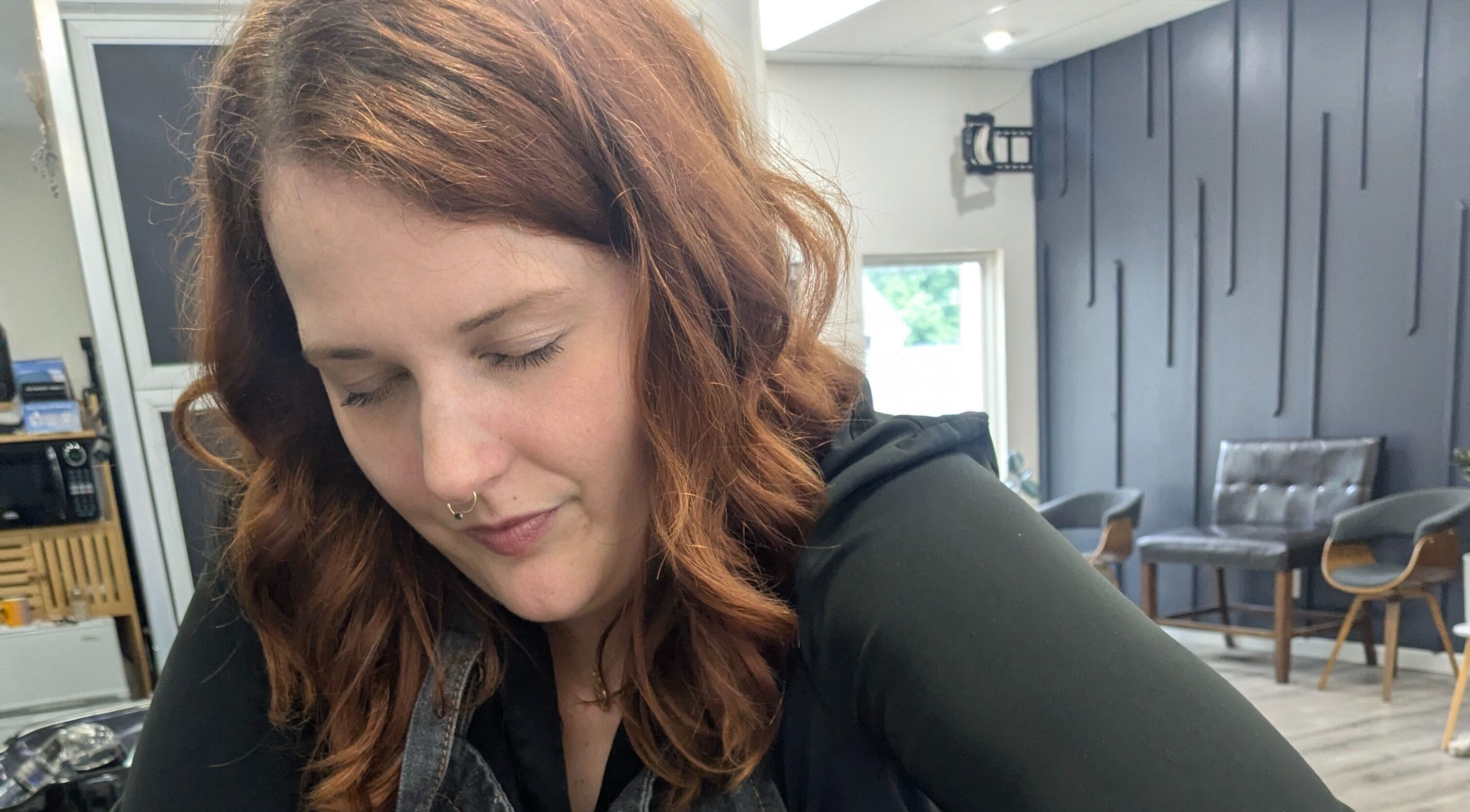 Stylist working at Sacred Beauty in Maryville, Illinois, US, with a serene expression.