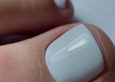 Elegant pedicure at VST Exclusive Spa Salon, Brooklyn, New York, US featuring glossy white polish.