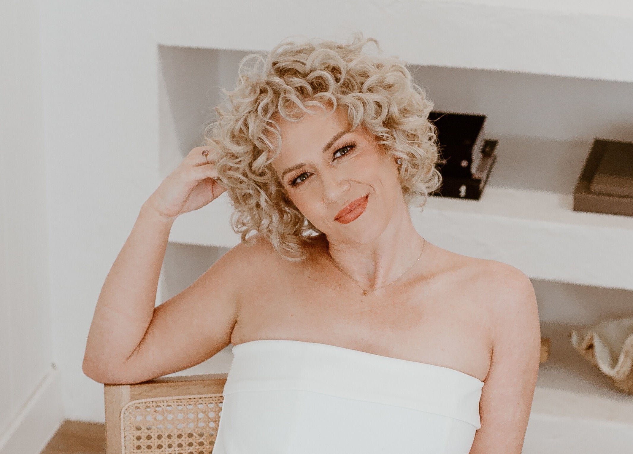 Woman with curly blonde hair smiling at Curly & Blonde, Bardon, Queensland, AU.