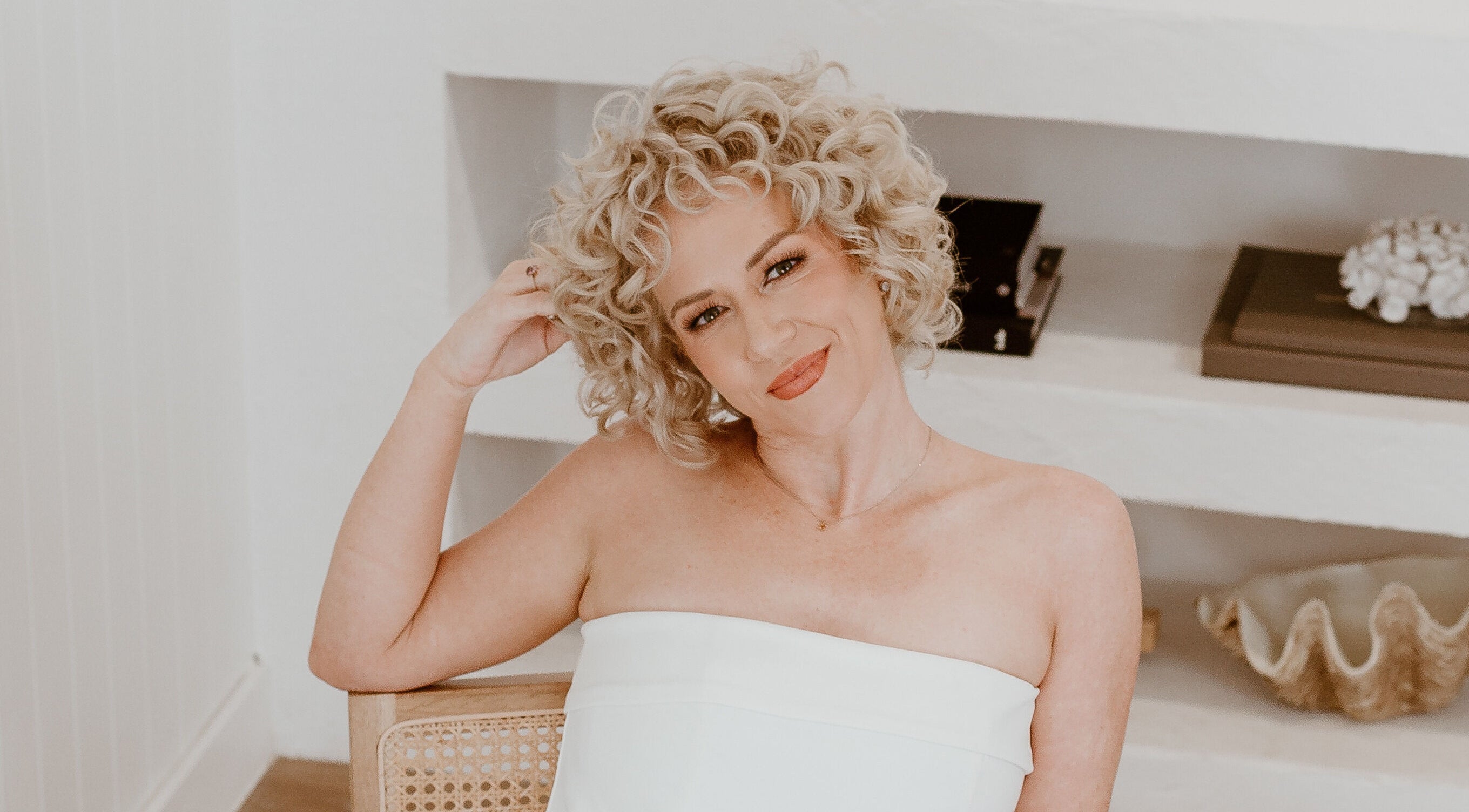 Woman with curly blonde hair smiling at Curly & Blonde, Bardon, Queensland, AU.
