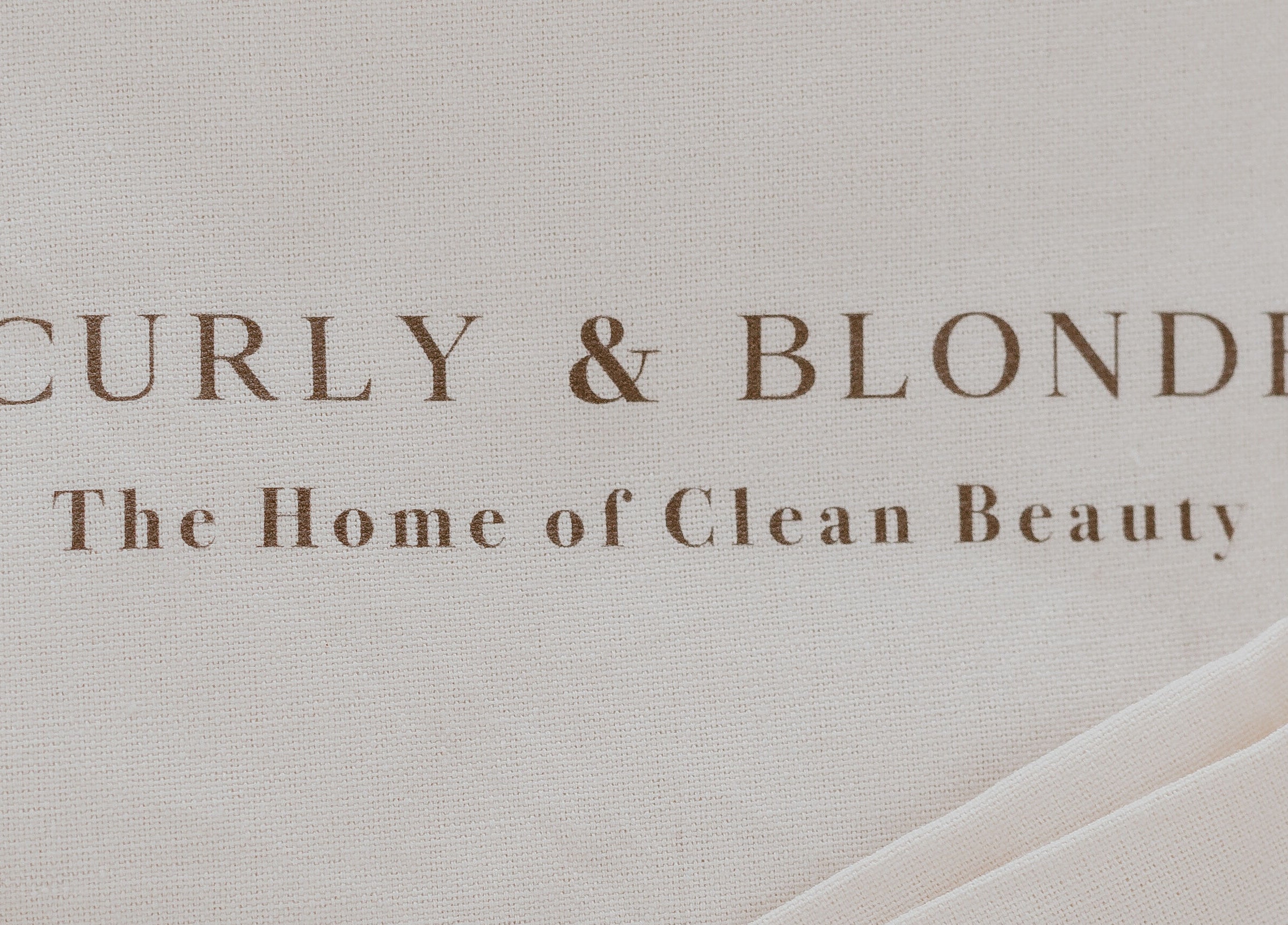 Curly & Blonde branding sign at Bardon, Queensland, AU, showcasing clean beauty ethos.