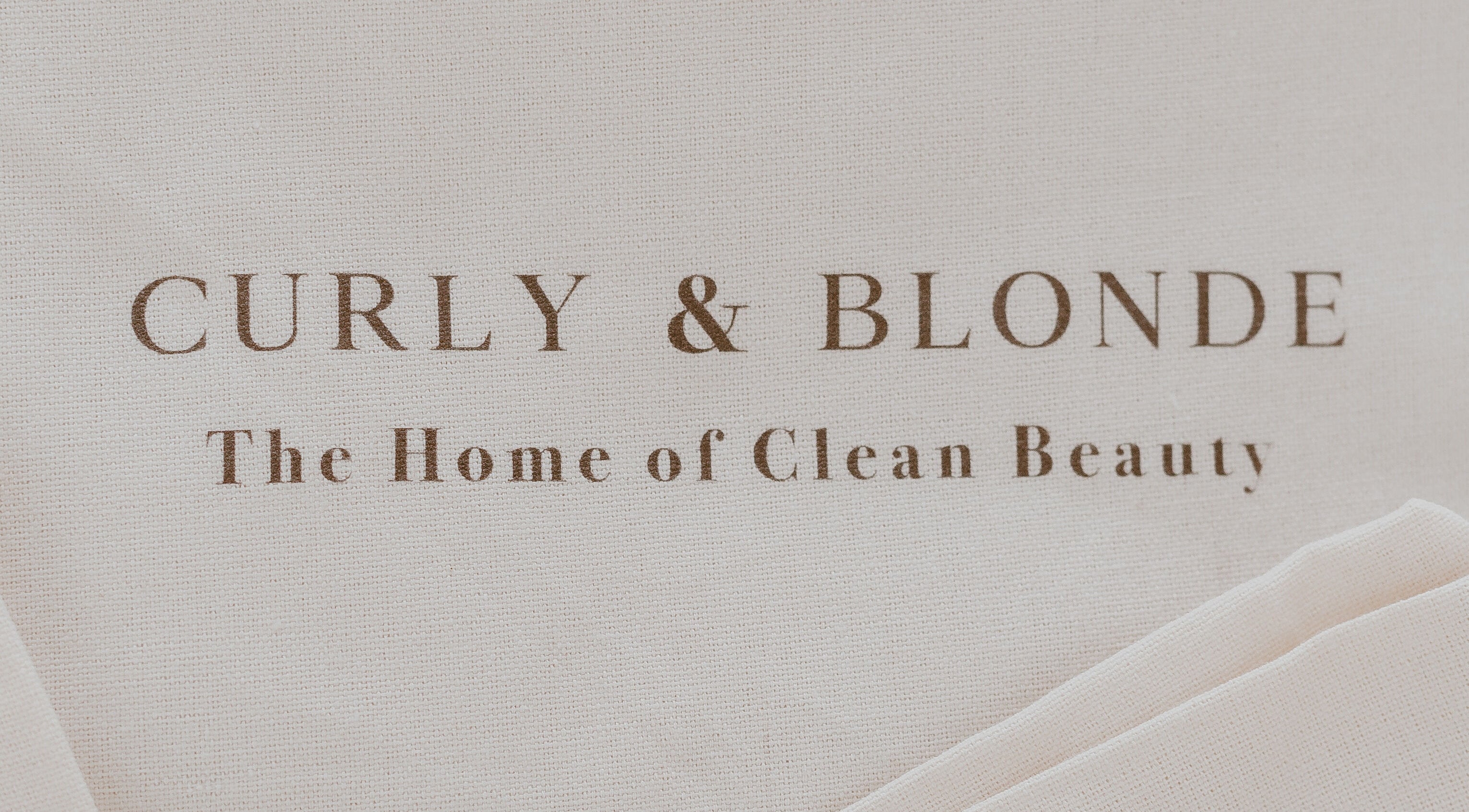 Curly & Blonde branding sign at Bardon, Queensland, AU, showcasing clean beauty ethos.