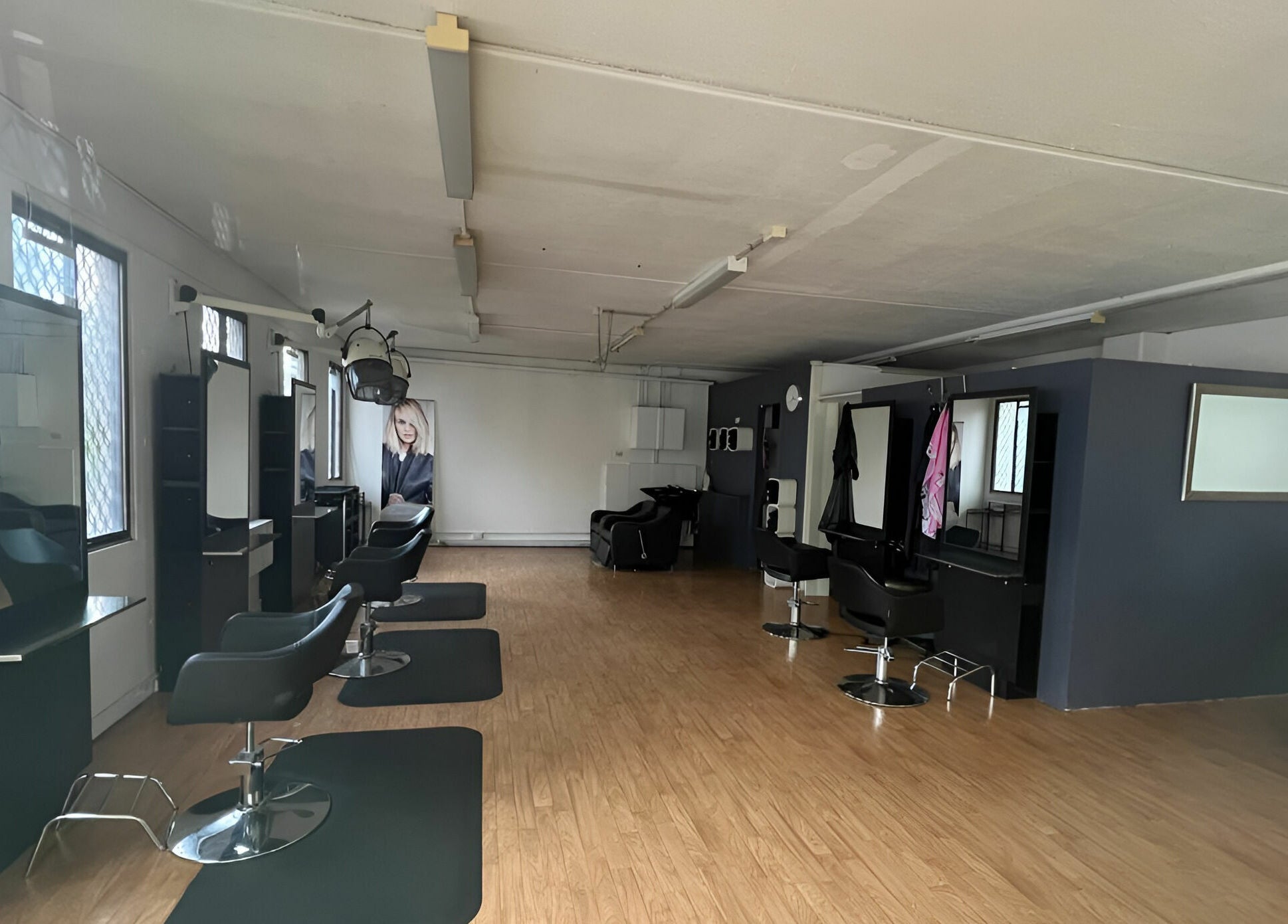 Modern salon interior of M2M By Michael in Penrith, New South Wales, AU featuring sleek design and styling stations.