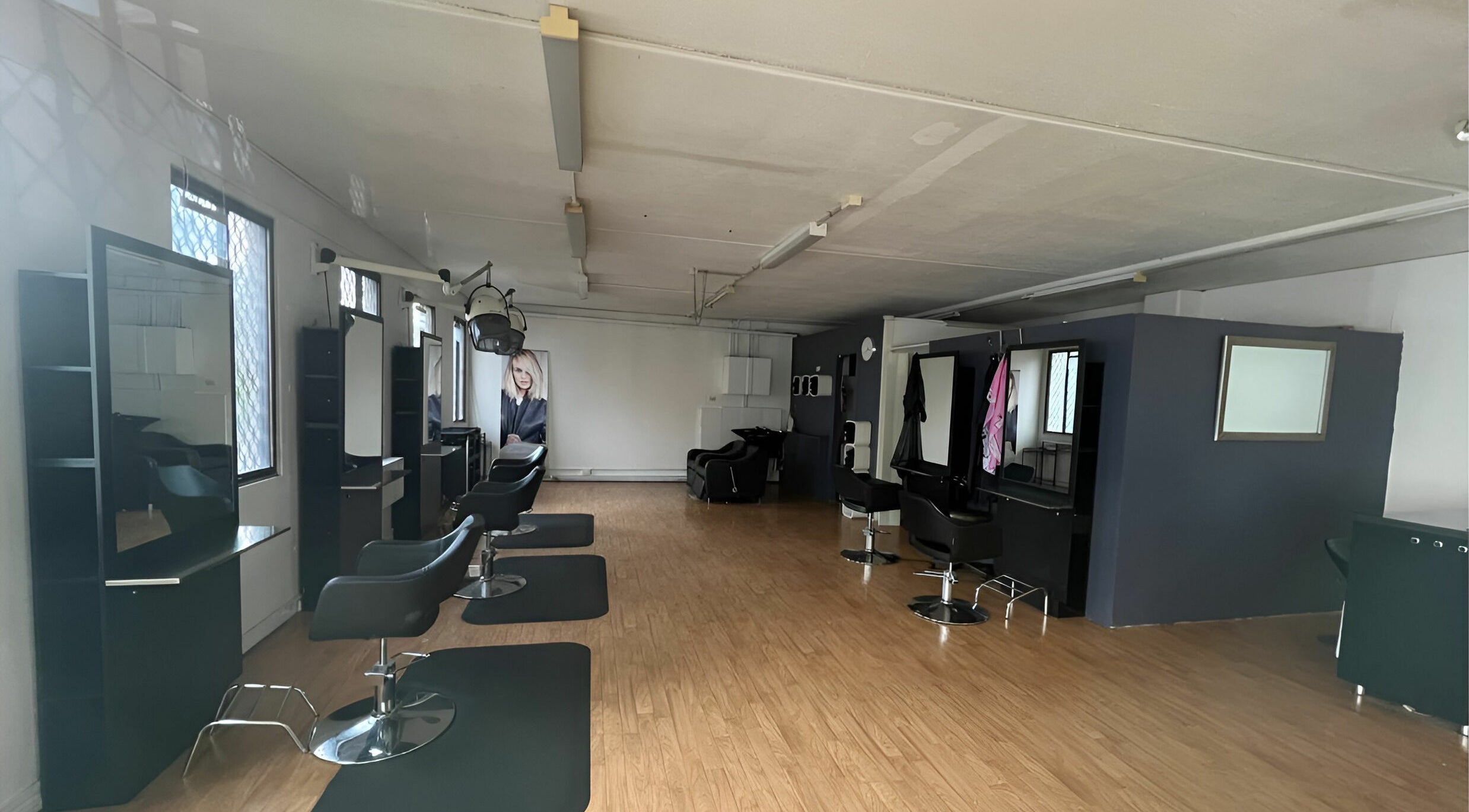 Modern salon interior of M2M By Michael in Penrith, New South Wales, AU featuring sleek design and styling stations.