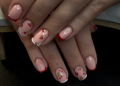 Elegant cherry-themed nail art at Groovy Beauty Studio, Idaho Falls, Idaho, US. Perfect for a stylish look.