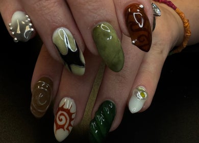 Intricate nail art at Groovy Beauty Studio, Idaho Falls, Idaho, US, showcasing vibrant colors and designs.