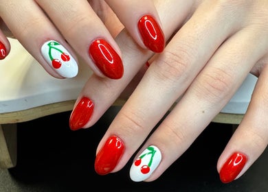 Cherry-themed red manicure at Groovy Beauty Studio, Idaho Falls, Idaho, US.