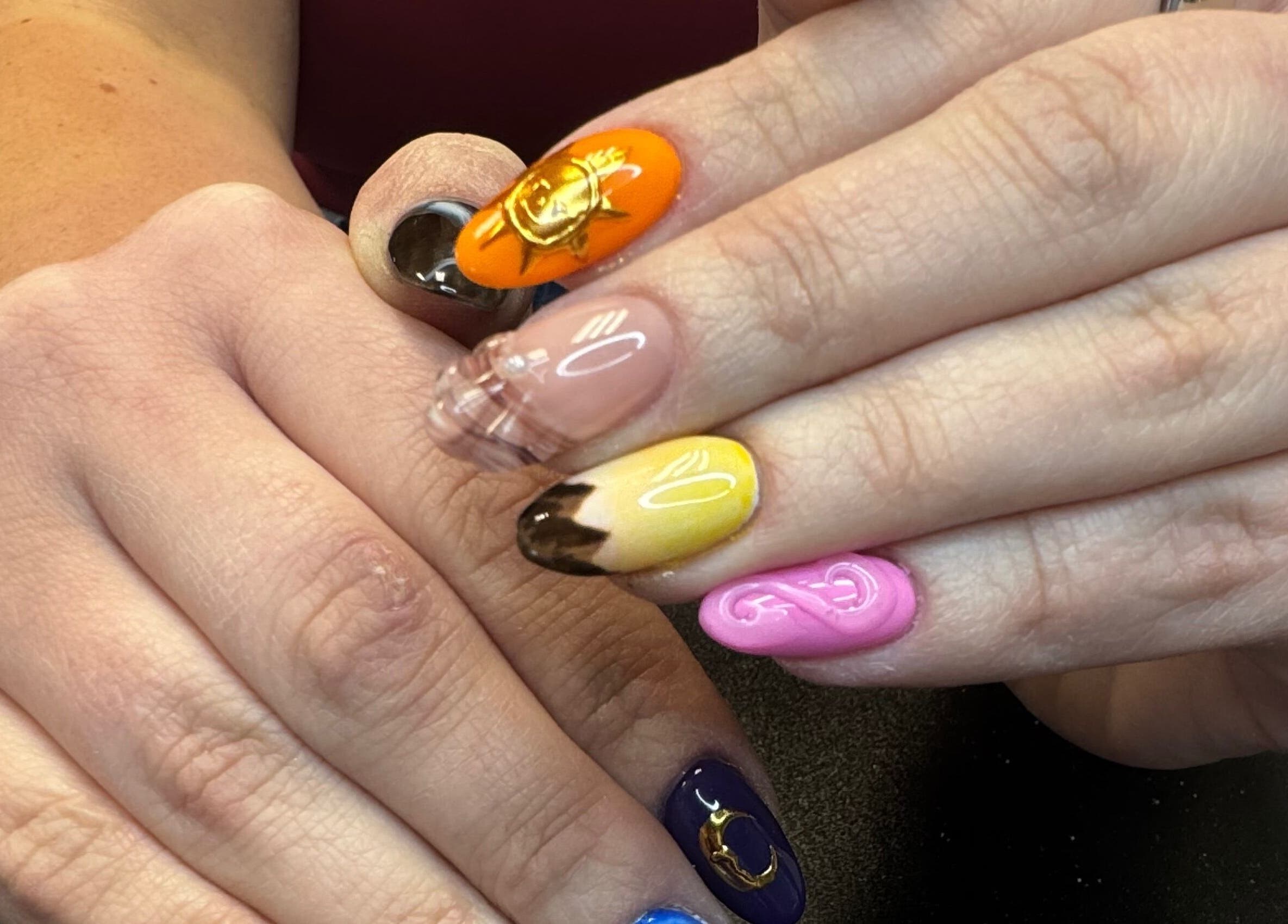 Colorful nail art on hands at Groovy Beauty Studio, Idaho Falls, Idaho, US.