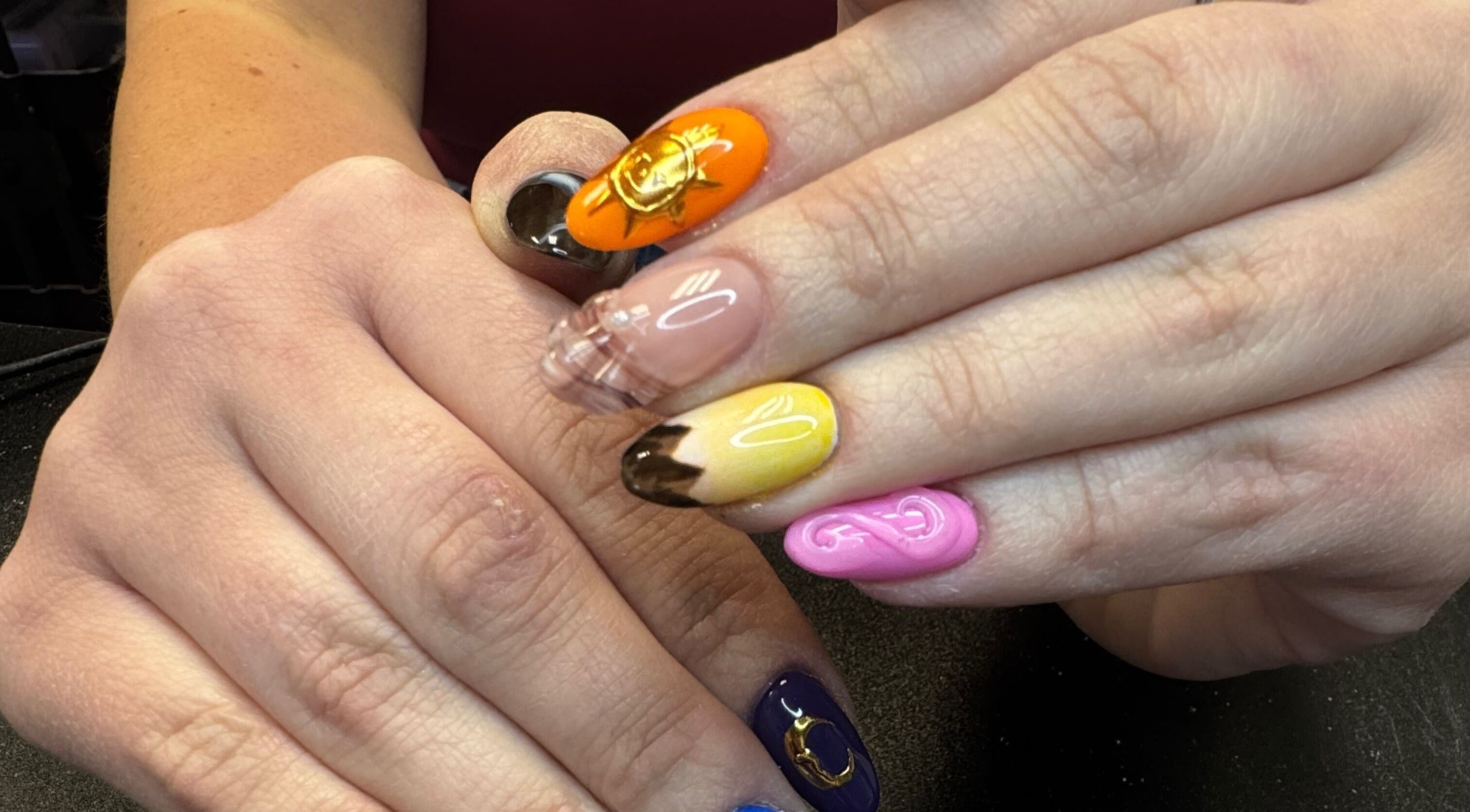 Colorful nail art on hands at Groovy Beauty Studio, Idaho Falls, Idaho, US.