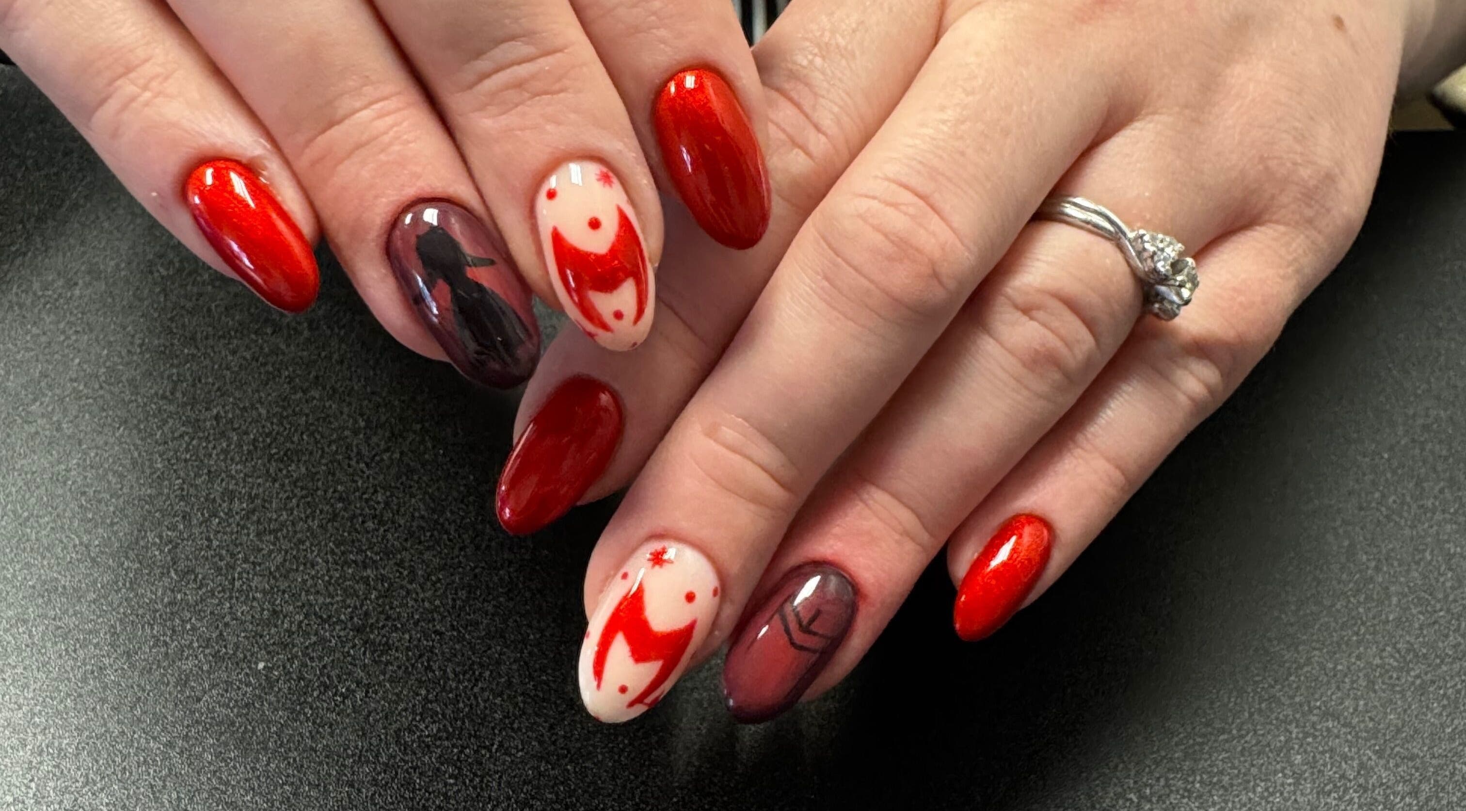 Nail art with red hues at Groovy Beauty Studio, Idaho Falls, Idaho, US. Elegant manicure design.