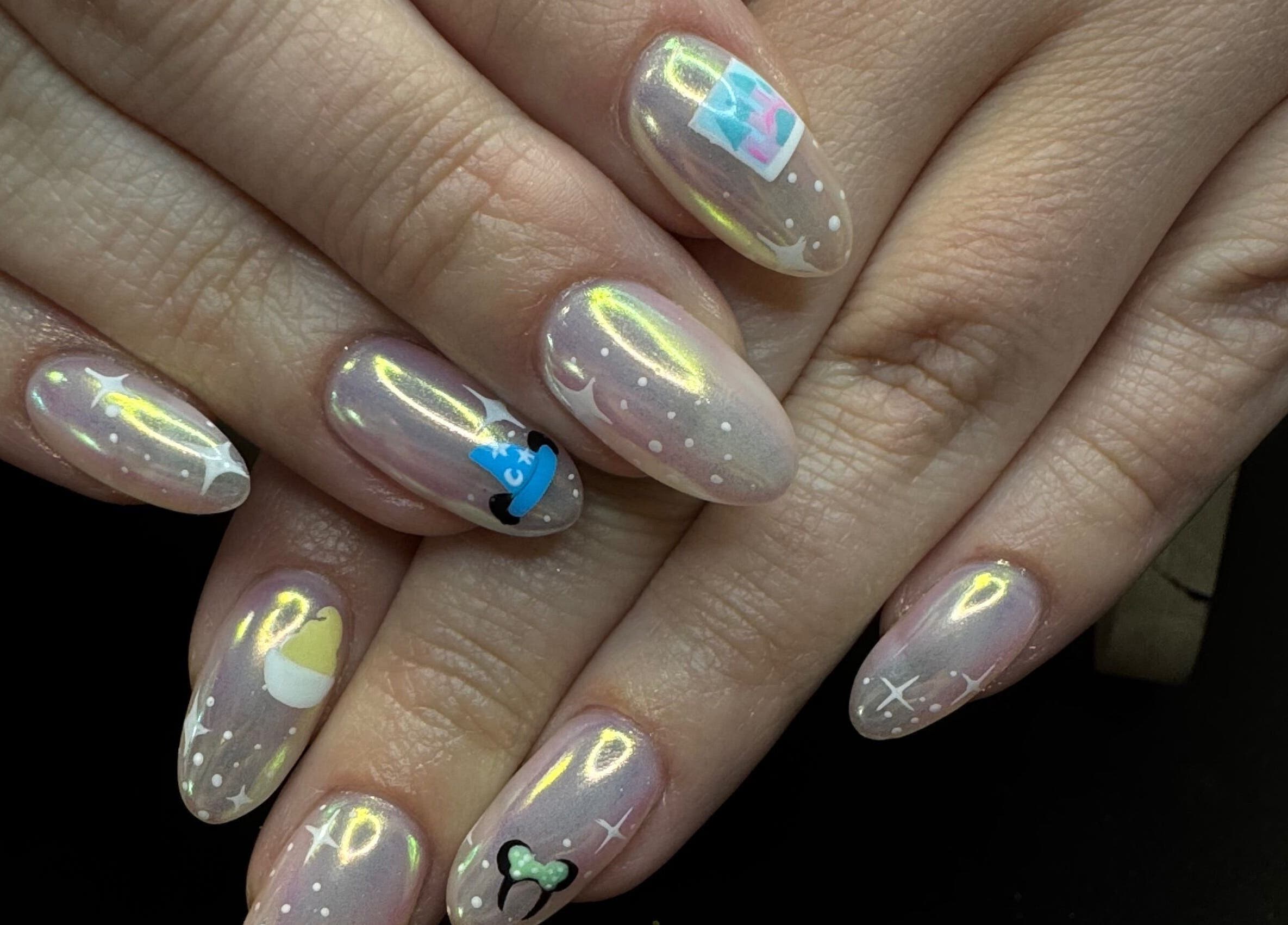 Unique cosmic nail art at Groovy Beauty Studio, Idaho Falls, Idaho, US. Shimmering designs create a celestial look.
