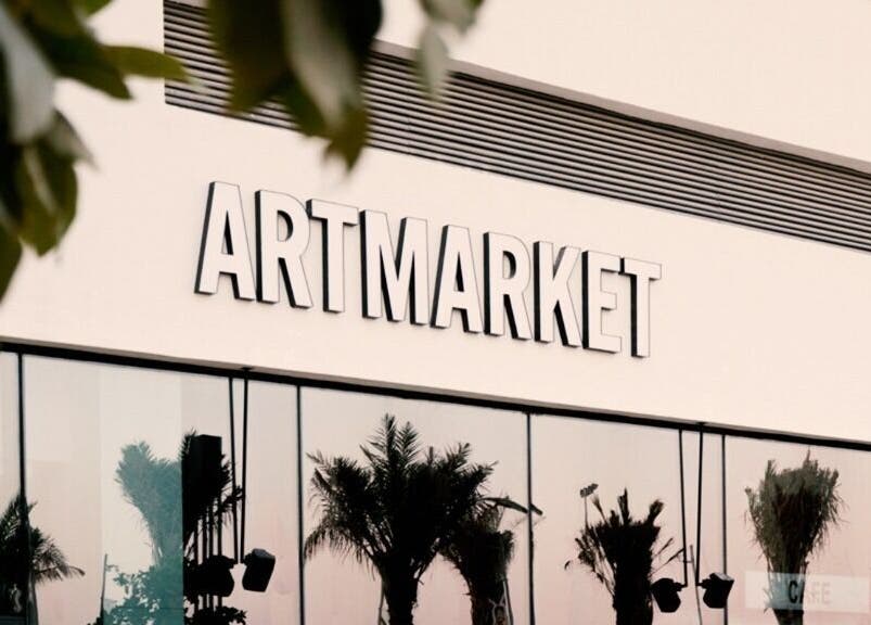 Exterior of Artmarket at Section Yas Bay, Abu Dhabi, AE with reflective glass and palm shadows.