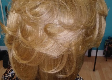 Elegant golden curls styled at Isl Hair Care, Lawrence, Kansas, US. Showcasing professional hair artistry.