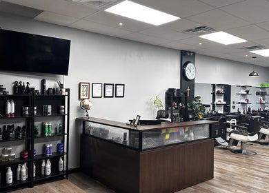 Interior of Yonan's Barber Shop, Hamilton, Ontario, CA, showcasing modern chairs and grooming products.