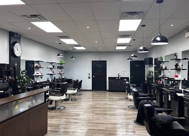 Modern interior of Yonan's Barber Shop in Hamilton, Ontario, CA with sleek workstations and stylish décor.