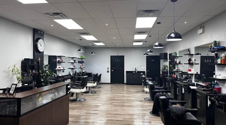 Modern interior of Yonan's Barber Shop in Hamilton, Ontario, CA with sleek workstations and stylish décor.