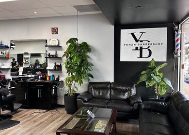 Interior of Yonan's Barber Shop in Hamilton, Ontario, CA, featuring modern seating and barber stations.