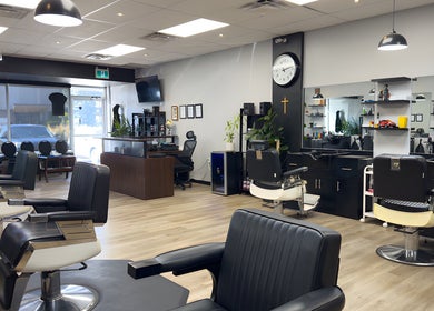 Interior of Yonan's Barber Shop in Hamilton, Ontario, CA, featuring stylish barber chairs and modern decor.