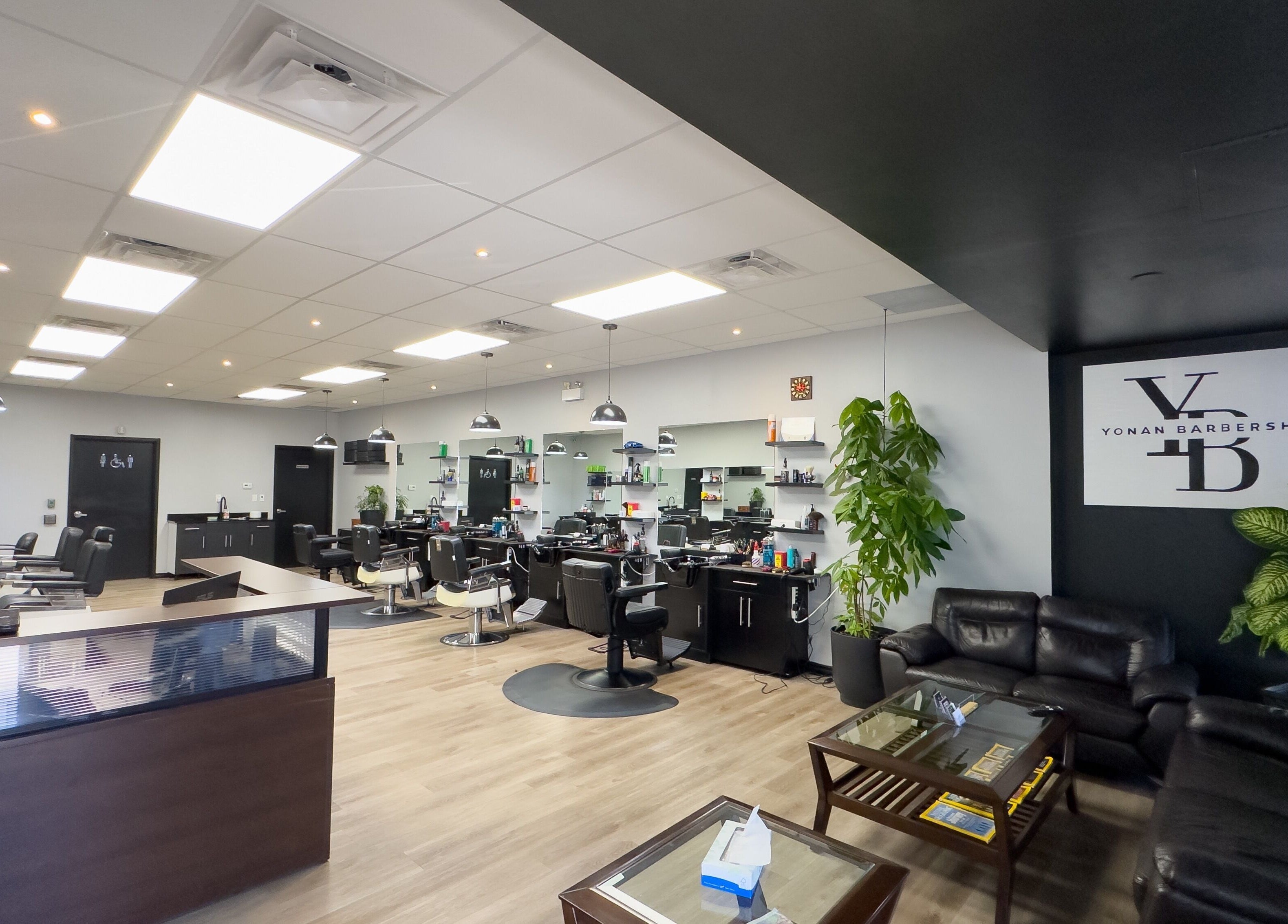 Spacious and modern interior of Yonan's Barber Shop in Hamilton, Ontario, CA with stylish chairs and decor.