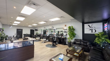 Spacious and modern interior of Yonan's Barber Shop in Hamilton, Ontario, CA with stylish chairs and decor.