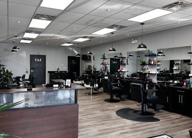 Bright interior of Yonan's Barber Shop in Hamilton, Ontario, CA, featuring sleek black chairs and contemporary decor.