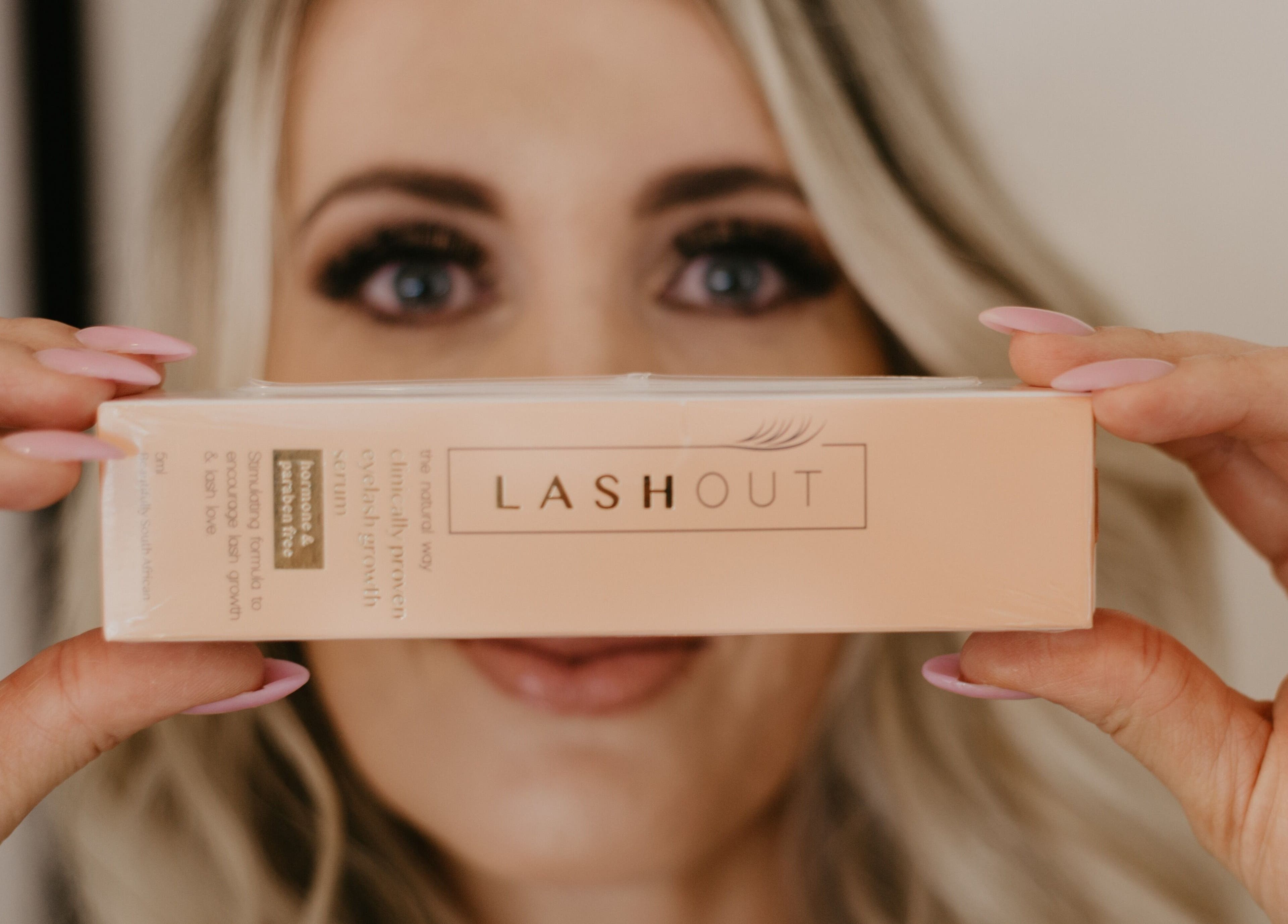 Close-up of Lashout product held by a woman at Femme Aesthetics, Pretoria, Gauteng, ZA.